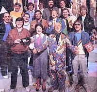 (L-R from back;) Richard Skinner, Gary Davies, Tommy Vance, Dave Lee Travis, (Centre row;) Andy Peebles, Peter Powell, Tony Blackburn, Mike Smith, Paul Gambaccini, Pat Sharp, (front row;) Simon Bates, Janice Long, Sir Jimmy Savile and Adrian John. Photograph taken during recording of the Top of the Pops 1000th edition, in May 1983.